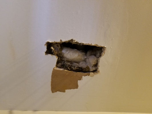 Pipe visible through a wall opening